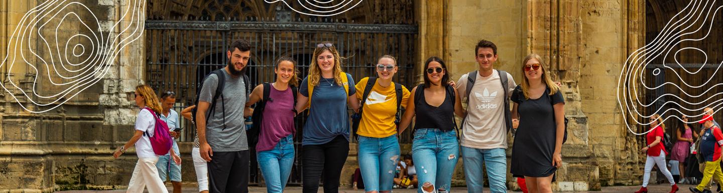 Students posing in front of a church in Spain