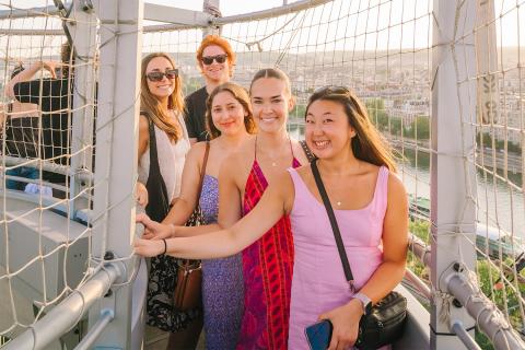 students on a hot air balloon flying over Paris, France