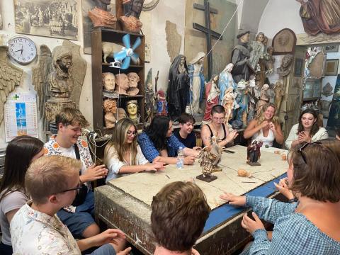 A group of college students working on a ceramics project in an art studio