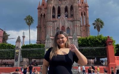 A young woman in front of a cathedral in Queretaro, Mexico.