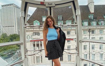 A young woman stands in a carriage on the London Eye