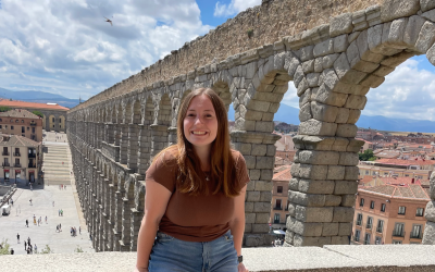 A young woman standing by arches in Segovia, Spain