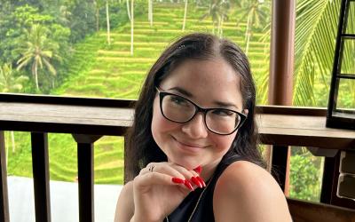 College-aged girl smiling with glasses. 